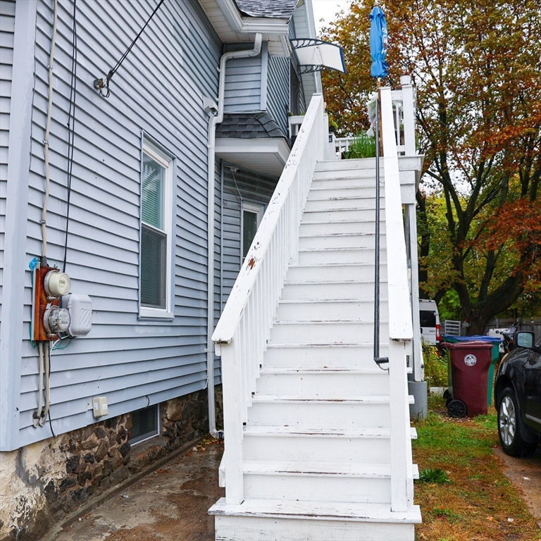 84 Cambridge Street Lowell, MA 01851 - Photo 4 of 42 a view of a house with a yard and sitting area