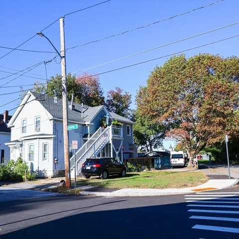 a view of street along with house and trees