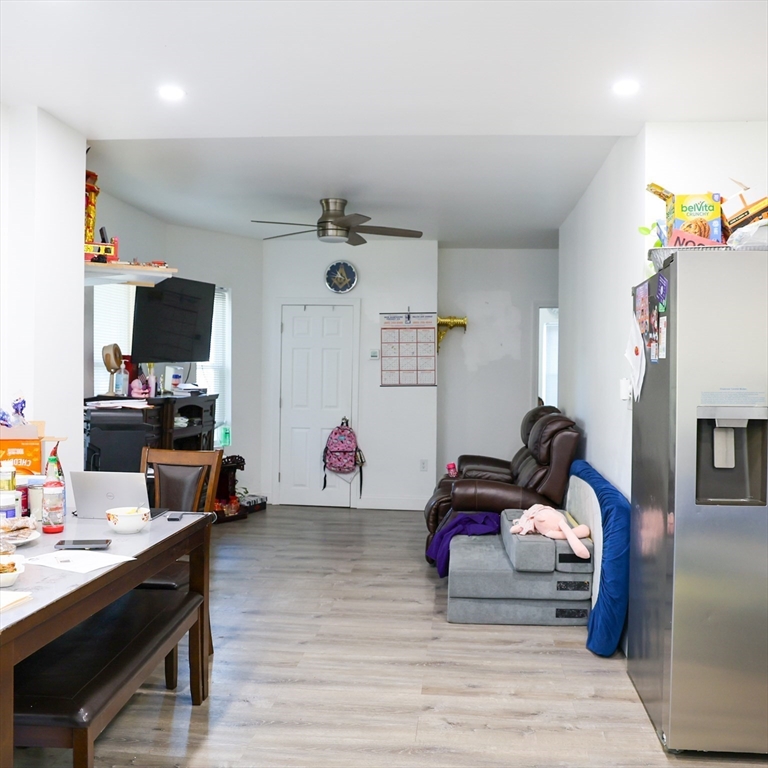 84 Cambridge Street Lowell, MA 01851 - Photo 9 of 42 a living room with furniture and a flat screen tv
