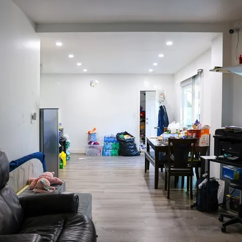a kitchen with stainless steel appliances kitchen island a refrigerator sink and cabinets