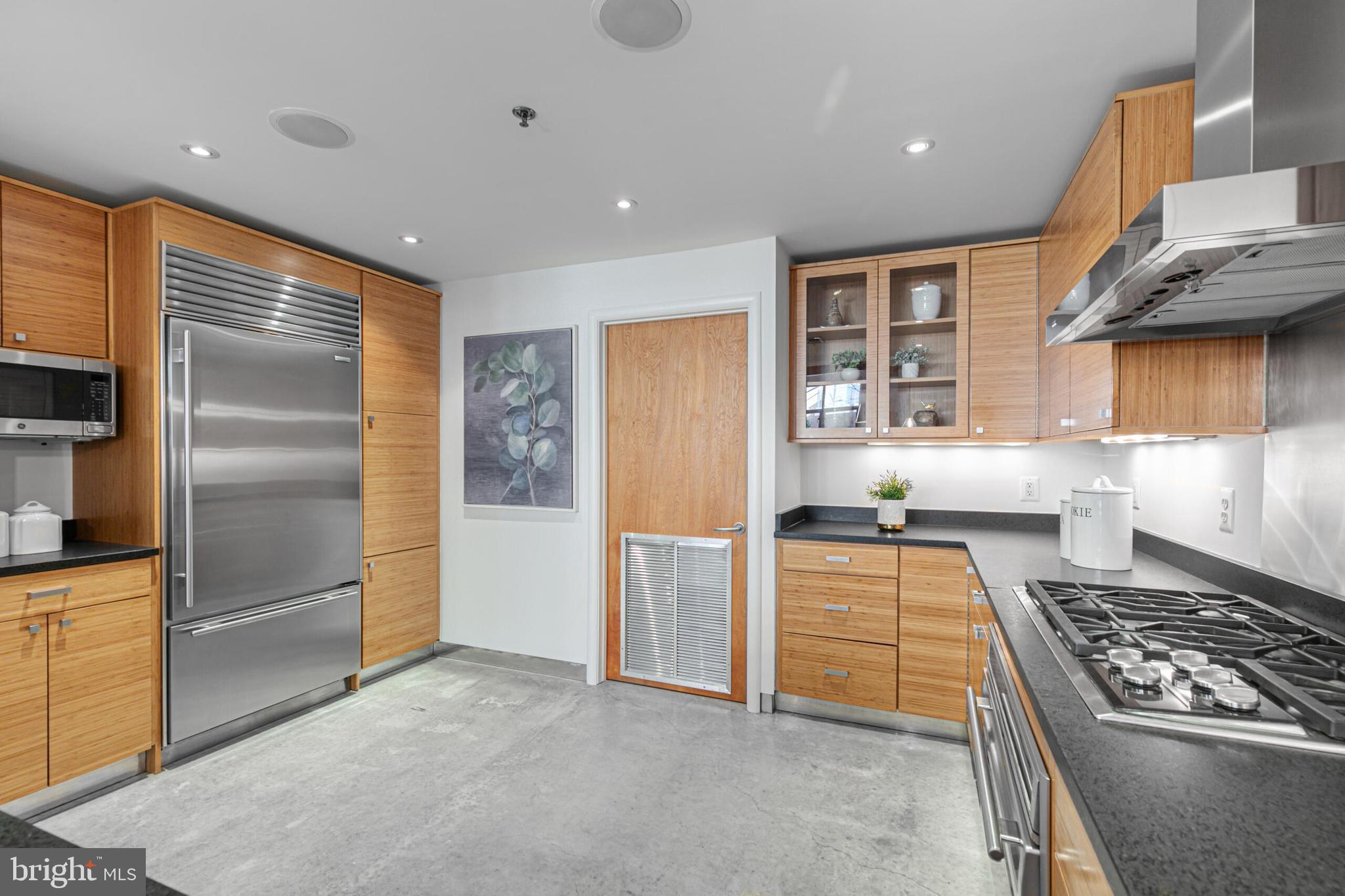2351 Champlain Street Northwest, Unit C1 Washington, DC 20009 - Photo 12 of 34 a kitchen with stainless steel appliances granite countertop a stove a refrigerator and a sink