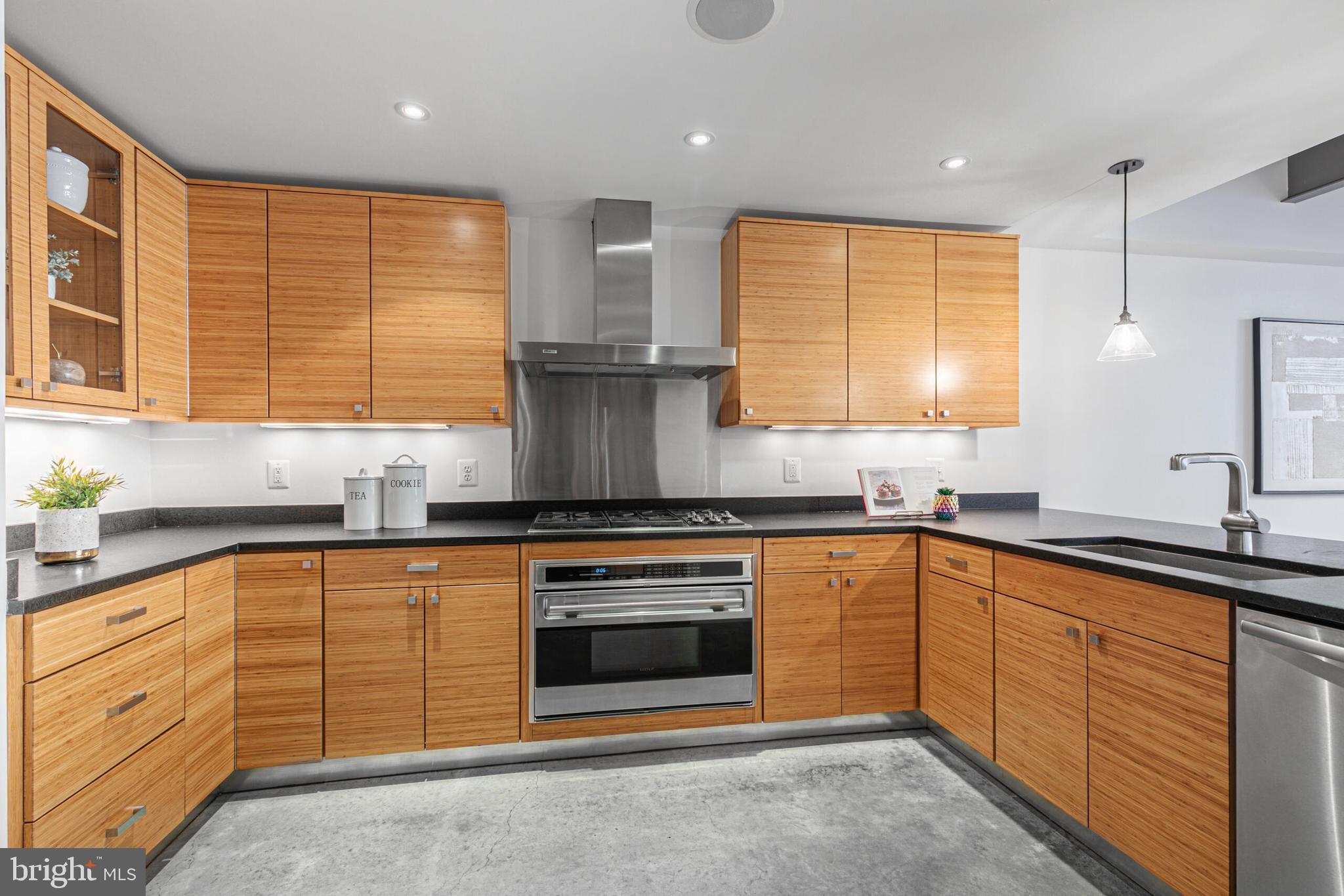 2351 Champlain Street Northwest, Unit C1 Washington, DC 20009 - Photo 14 of 34 a kitchen with stainless steel appliances granite countertop a sink a stove and a microwave