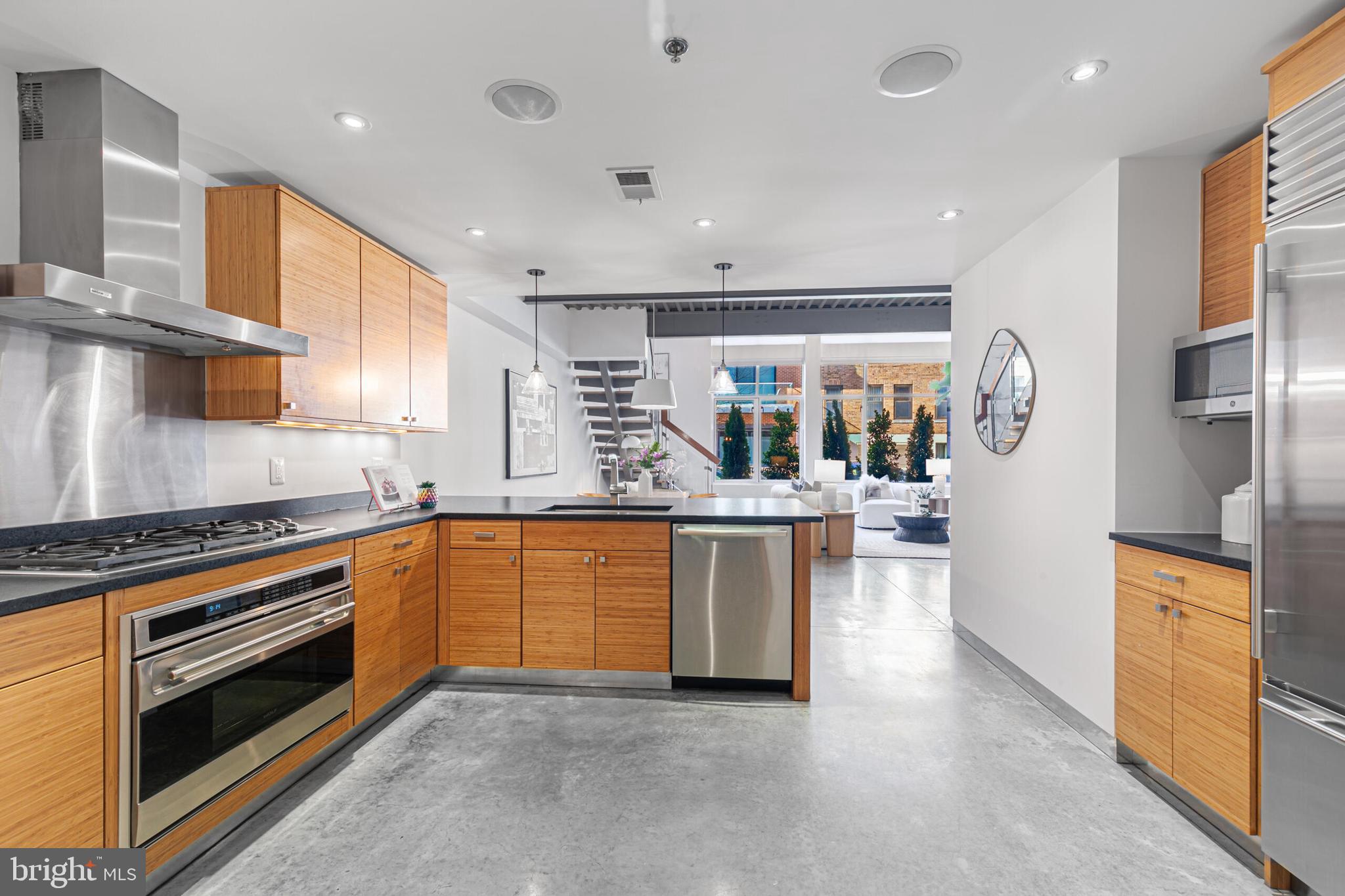 2351 Champlain Street Northwest, Unit C1 Washington, DC 20009 - Photo 15 of 34 a kitchen with stainless steel appliances granite countertop a stove top oven a sink a refrigerator and white cabinets