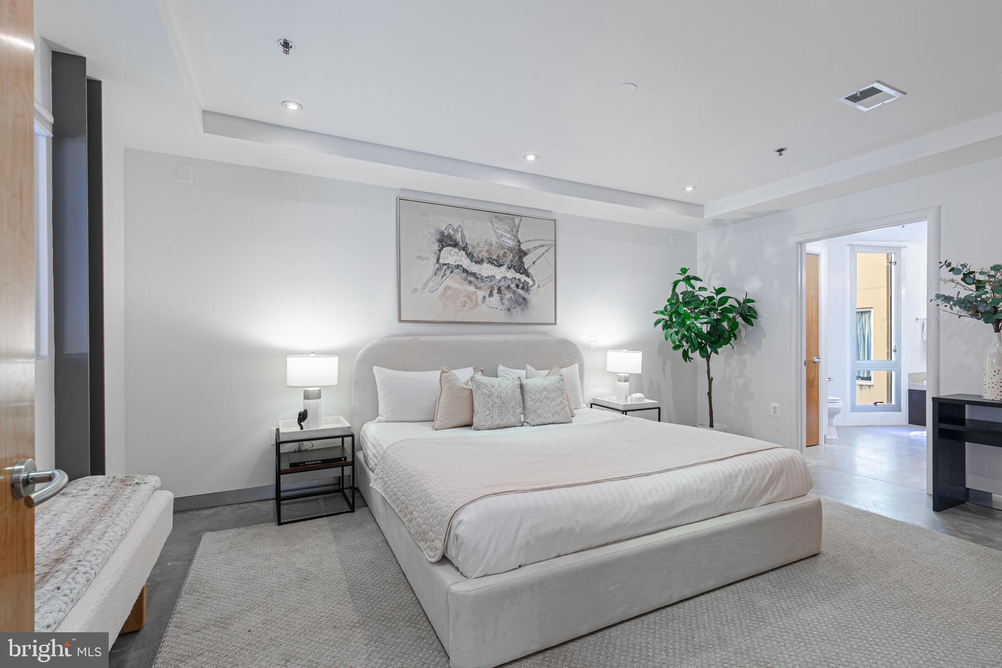 2351 Champlain Street Northwest, Unit C1 Washington, DC 20009 - Photo 19 of 34 a spacious bedroom with a large bed and a couch