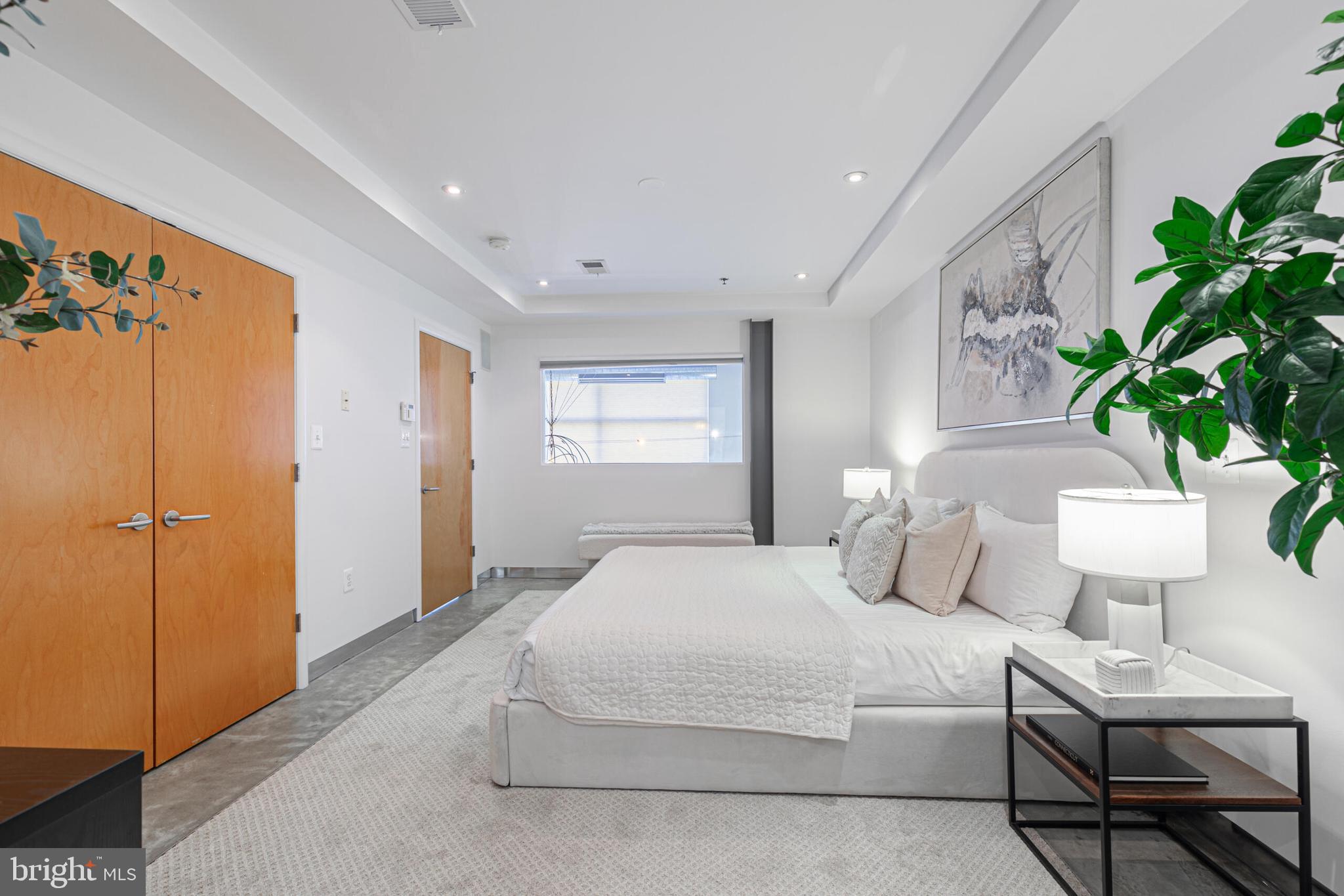 2351 Champlain Street Northwest, Unit C1 Washington, DC 20009 - Photo 21 of 34 a bedroom with a large bed and a potted plant