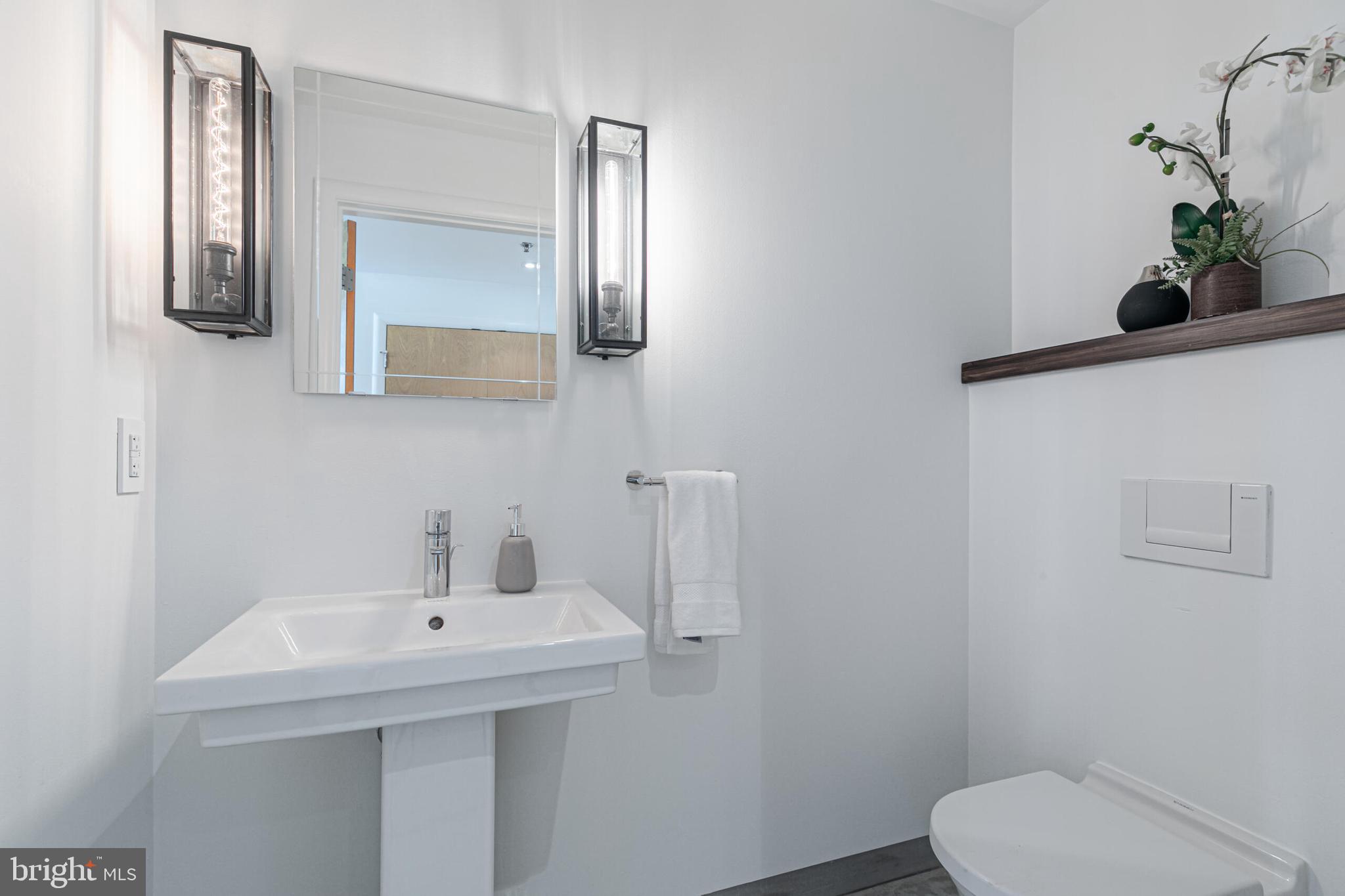 2351 Champlain Street Northwest, Unit C1 Washington, DC 20009 - Photo 24 of 34 a bathroom with a toilet a sink and mirror