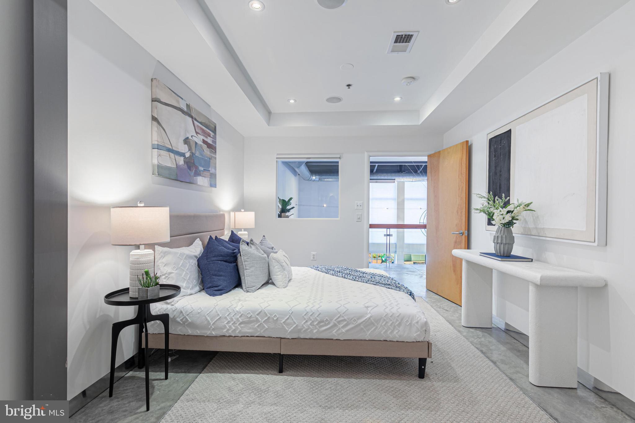 2351 Champlain Street Northwest, Unit C1 Washington, DC 20009 - Photo 25 of 34 a bedroom with a large bed and a chandelier