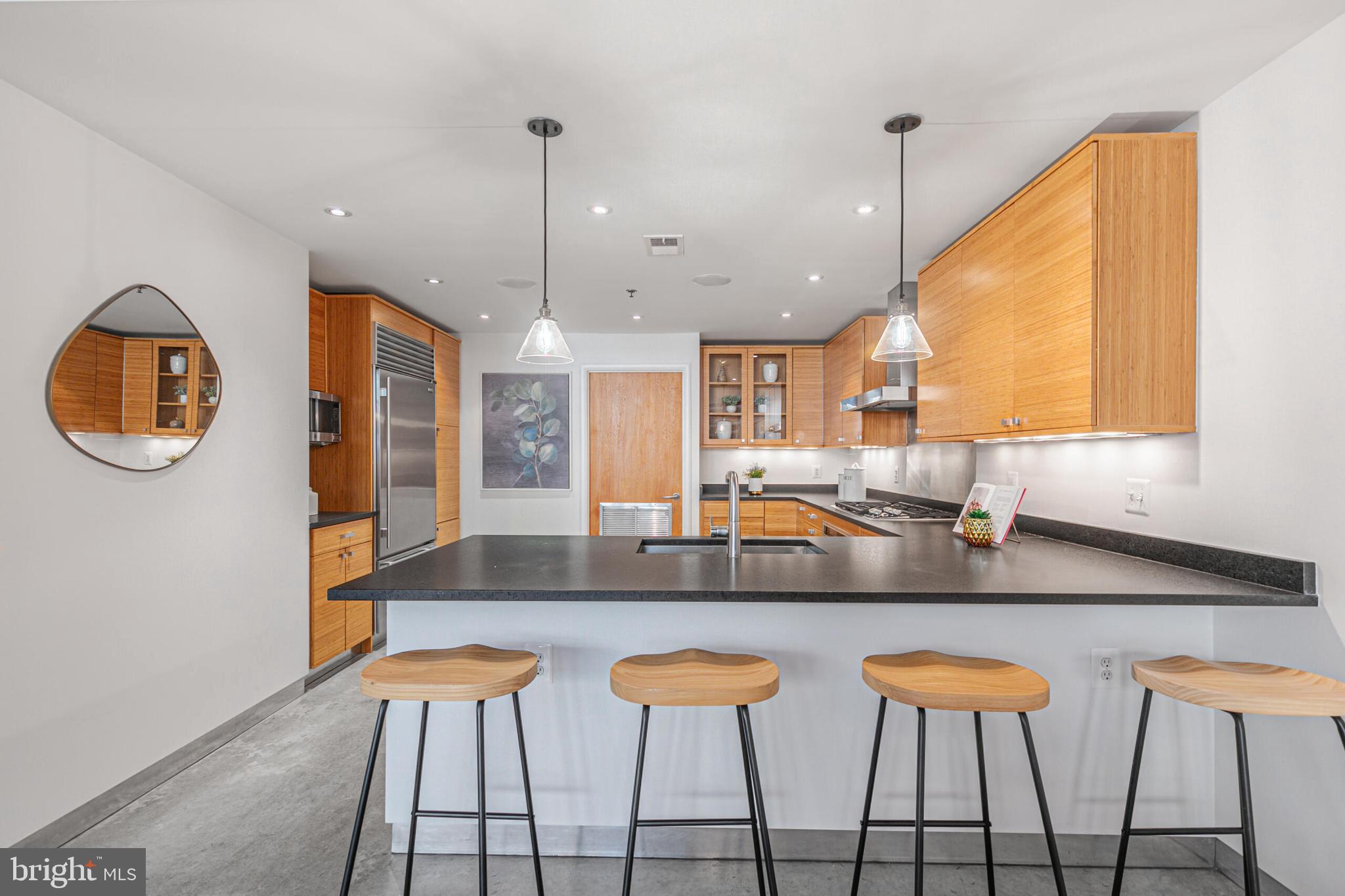 2351 Champlain Street Northwest, Unit C1 Washington, DC 20009 - Photo 10 of 34 a kitchen with stainless steel appliances granite countertop a sink and a large window