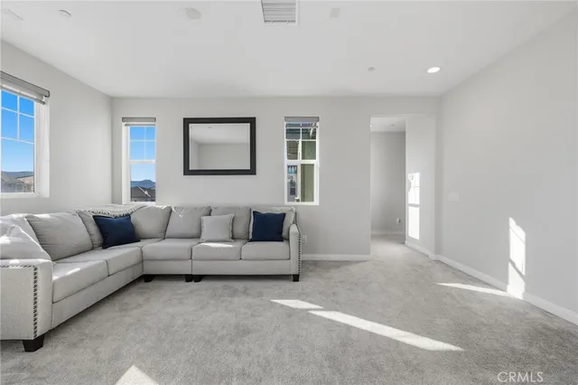 a living room with furniture and a night stand