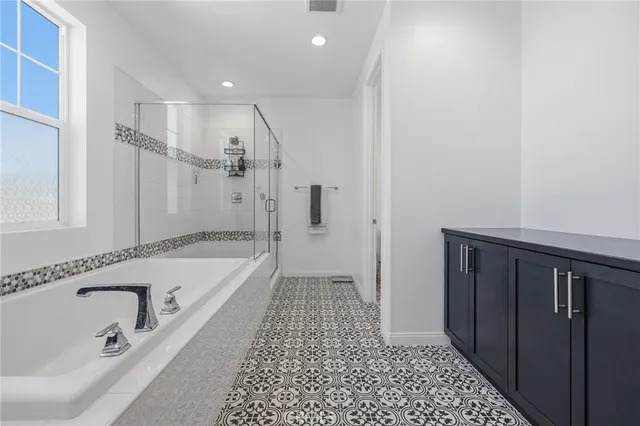 a bathroom with a bathtub and a shower