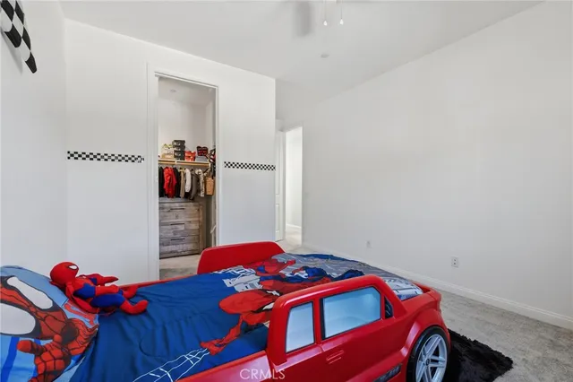 a kids bedroom with a bed and a window