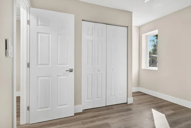 an empty room with wooden floor