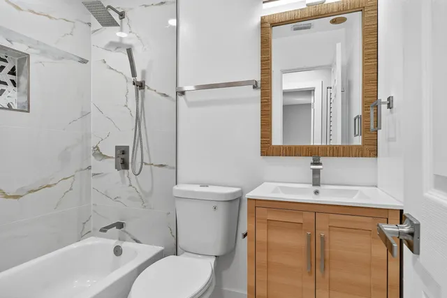 a bathroom with a sink toilet and shower
