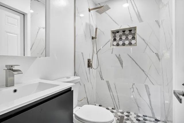 a bathroom with a sink toilet and shower