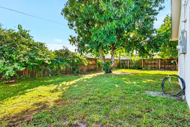 a view of yard with swimming pool and garden