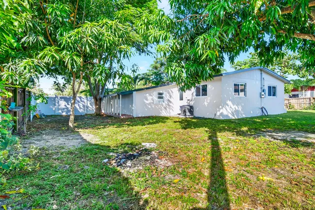 a view of a house with pool and a garden