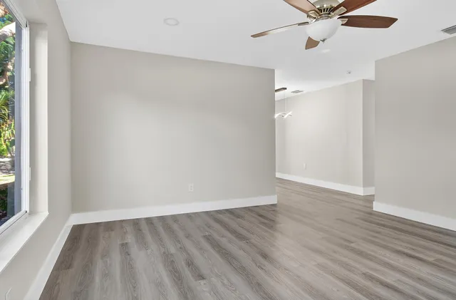 wooden floor in an empty room with a window
