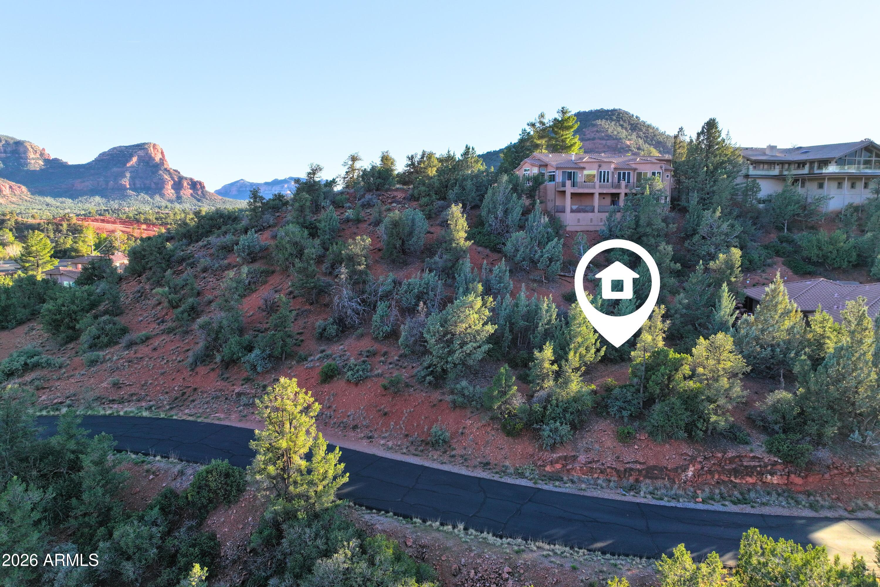 256 Barcelona Road, Unit 81 Sedona, AZ 86336 - Photo 12 of 14 a view of a house with a yard and a wooden fence