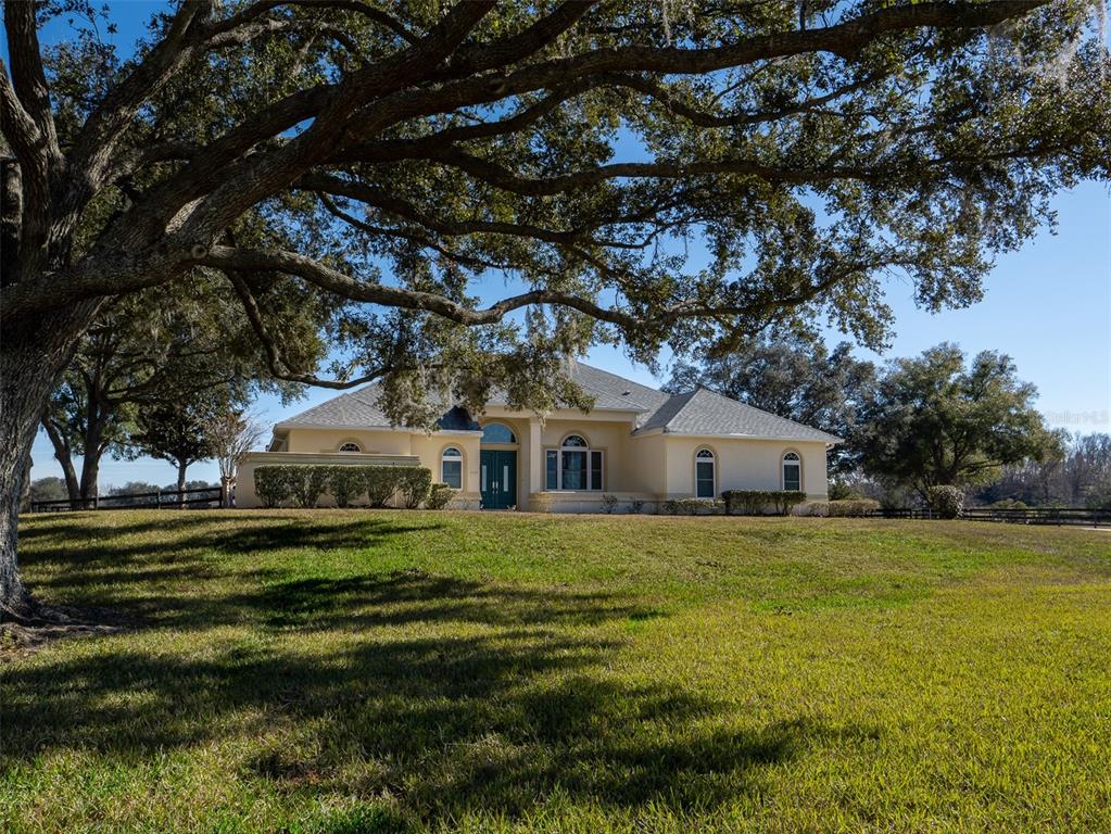 2185 Northwest 114th Loop Ocala, FL 34475 - Photo 2 of 25 a front view of house with yard and green space