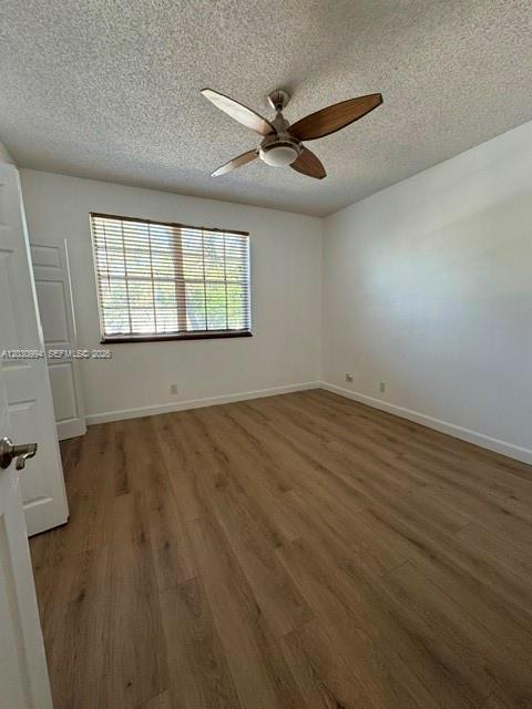 192 Southwest 96th Avenue, Unit 192 Plantation, FL 33324 - Photo 14 of 15 an empty room with wooden floor and windows