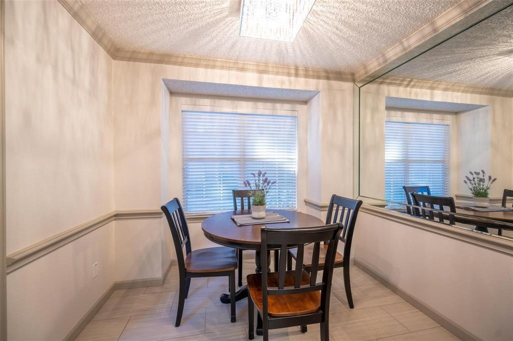 17735 Windflower Way, Unit 105 Dallas, TX 75252 - Photo 12 of 32 a view of a dining room with furniture and window