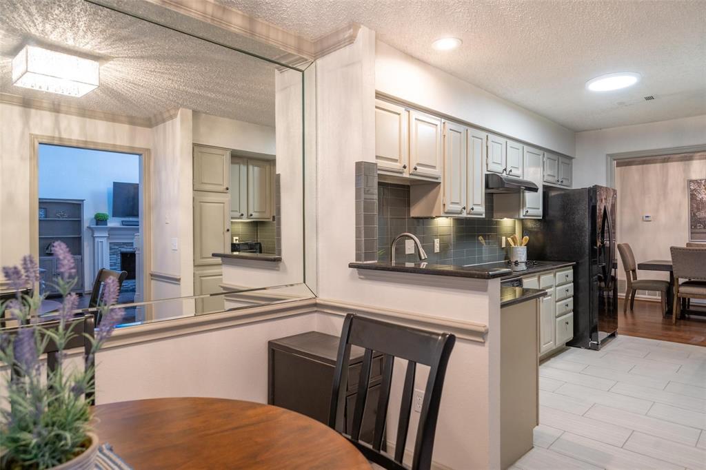 17735 Windflower Way, Unit 105 Dallas, TX 75252 - Photo 13 of 32 a kitchen with stainless steel appliances a refrigerator stove microwave and sink