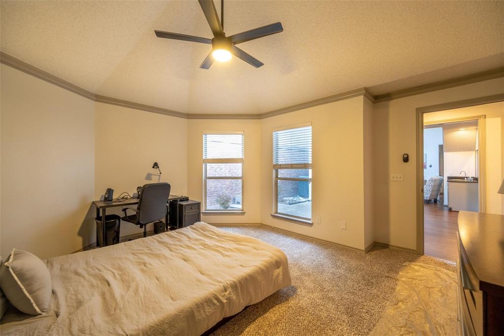 17735 Windflower Way, Unit 105 Dallas, TX 75252 - Photo 15 of 32 a bedroom with a bed and wooden floor