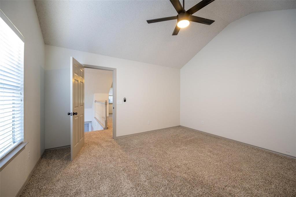 17735 Windflower Way, Unit 105 Dallas, TX 75252 - Photo 21 of 32 an empty room with closet and a chandelier fan