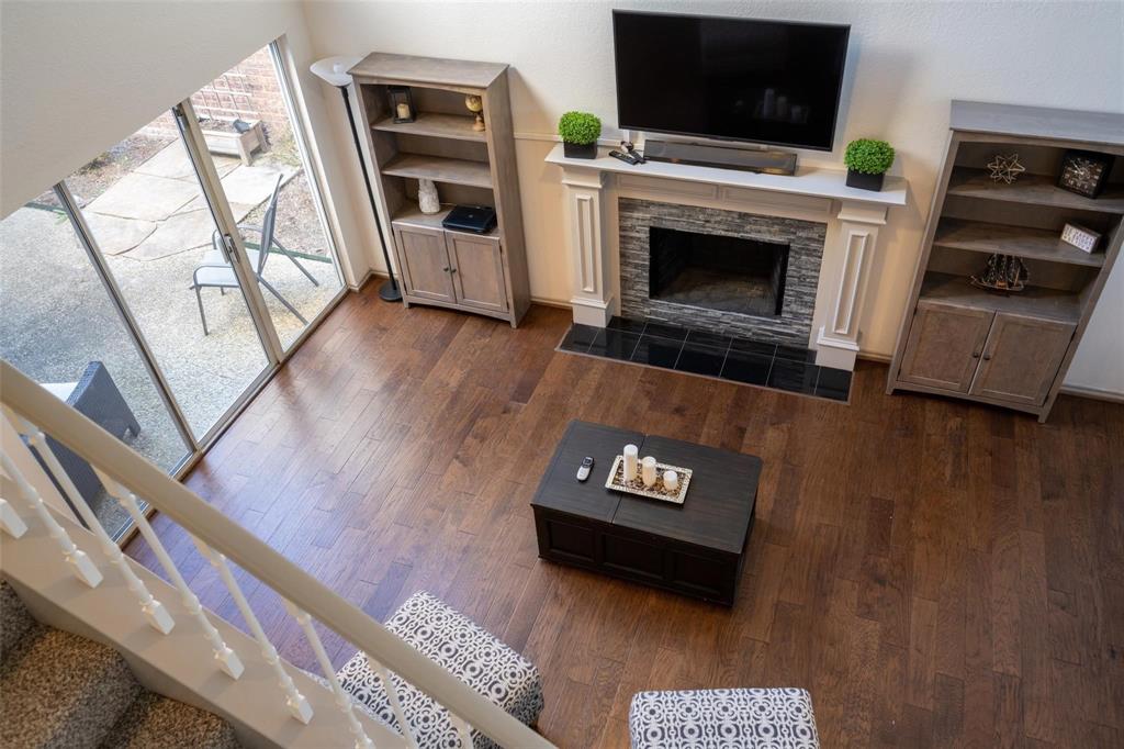17735 Windflower Way, Unit 105 Dallas, TX 75252 - Photo 23 of 32 a living room with furniture a flat screen tv and a fireplace