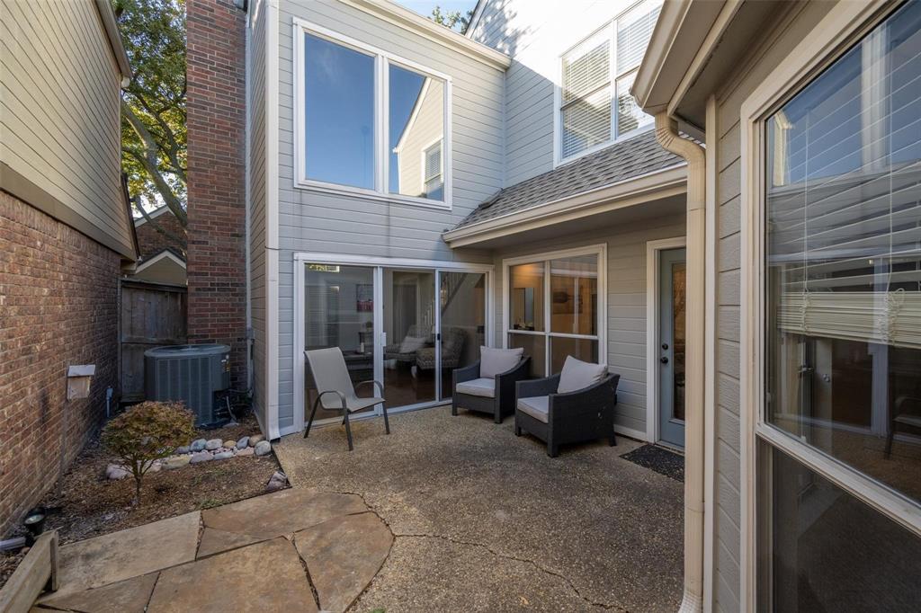 17735 Windflower Way, Unit 105 Dallas, TX 75252 - Photo 26 of 32 a view of a house with backyard sitting area and porch