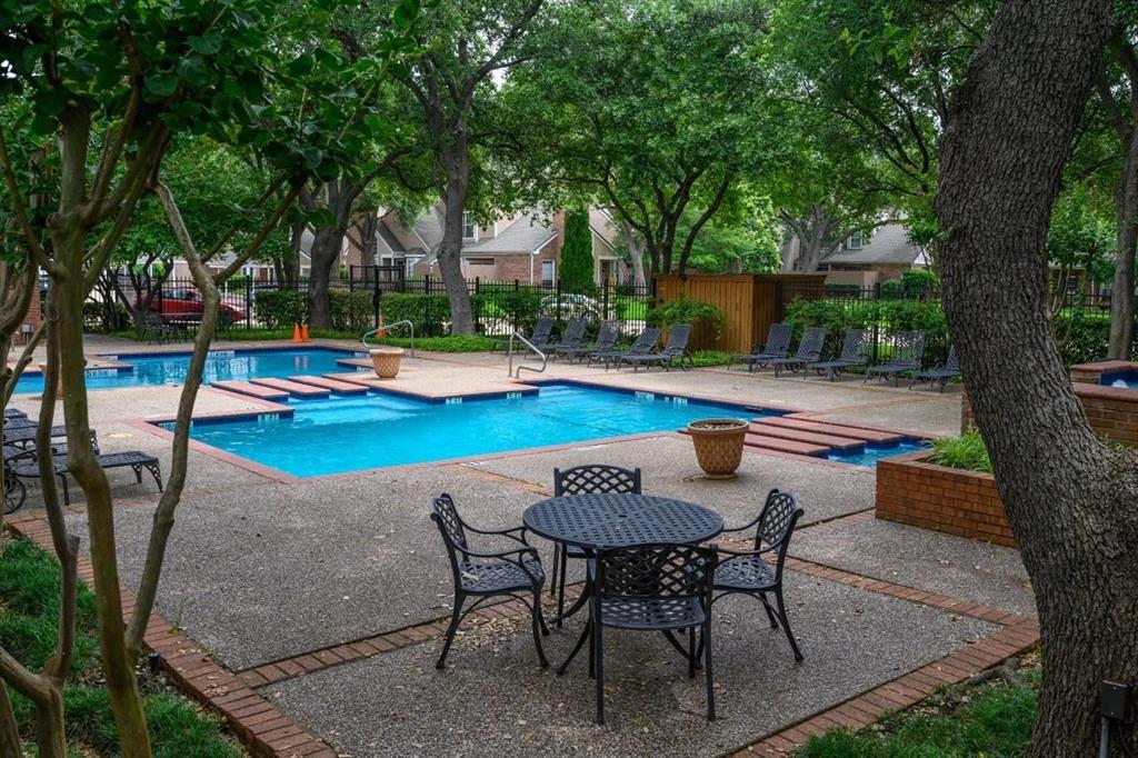 17735 Windflower Way, Unit 105 Dallas, TX 75252 - Photo 30 of 32 a view of swimming pool with lawn chairs and plants