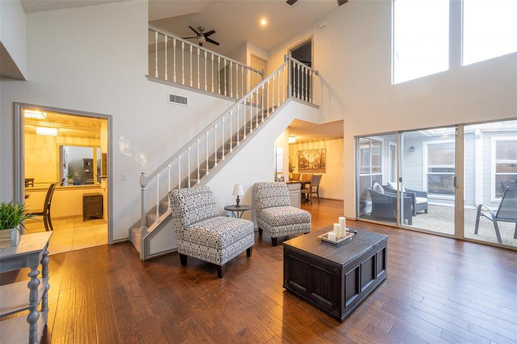 17735 Windflower Way, Unit 105 Dallas, TX 75252 - Photo 4 of 32 a living room with furniture and a table with wooden floor