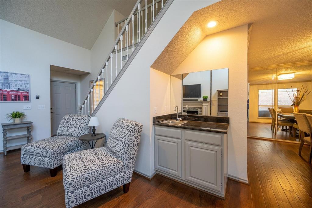 17735 Windflower Way, Unit 105 Dallas, TX 75252 - Photo 7 of 32 a living room with furniture and a flat screen tv