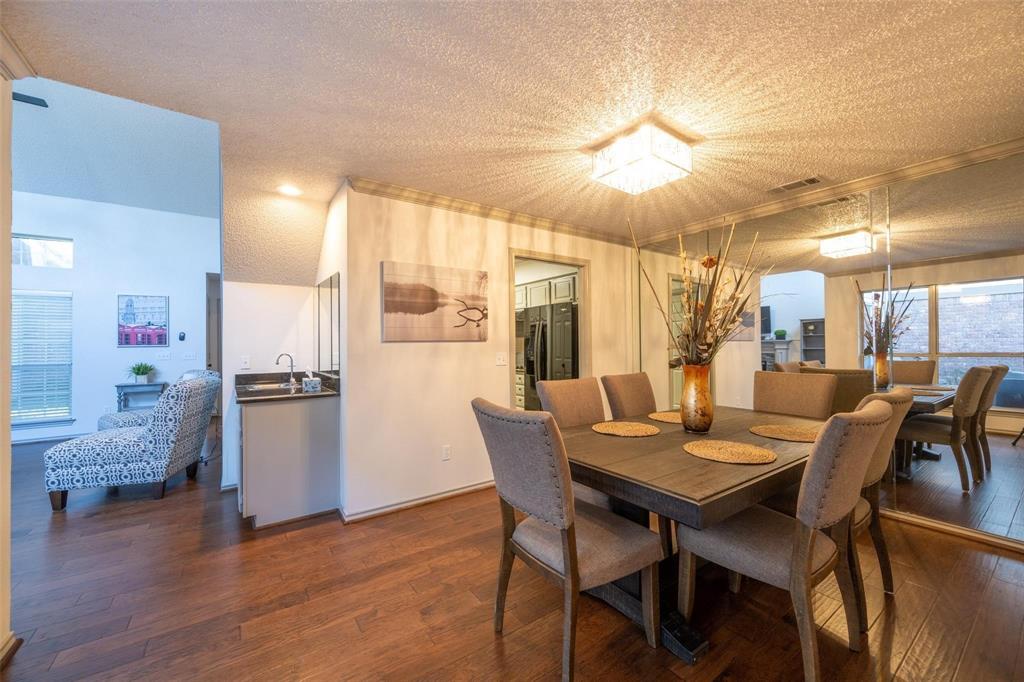 17735 Windflower Way, Unit 105 Dallas, TX 75252 - Photo 9 of 32 a view of a dining room with furniture and wooden floor