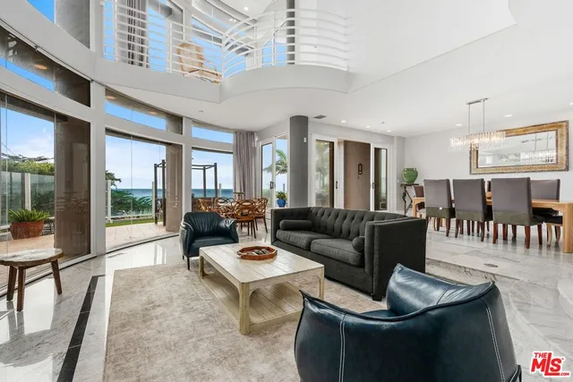 a living room with furniture and a floor to ceiling window