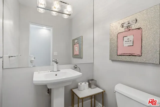 a bathroom with a sink a mirror and vanity