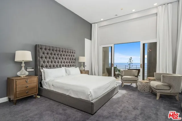 a bedroom with a bed and a lamp