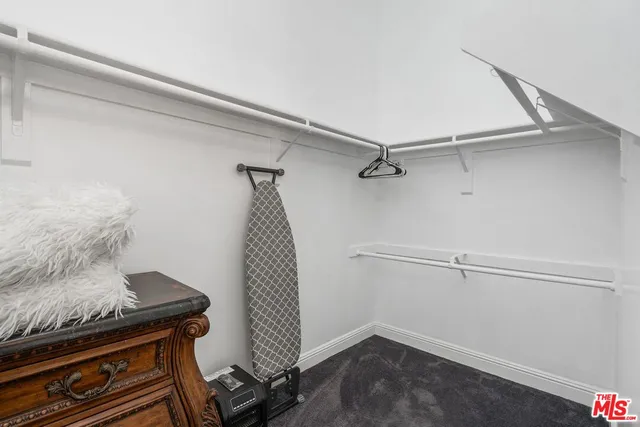 a large bed sitting in a room next to a window