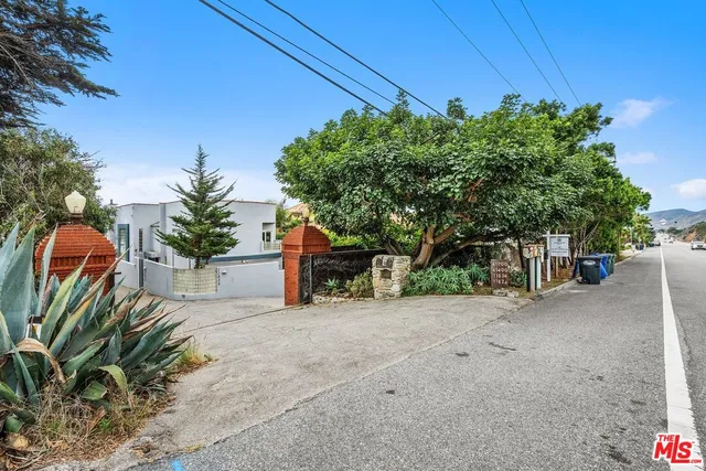 a view of a house with potted plants