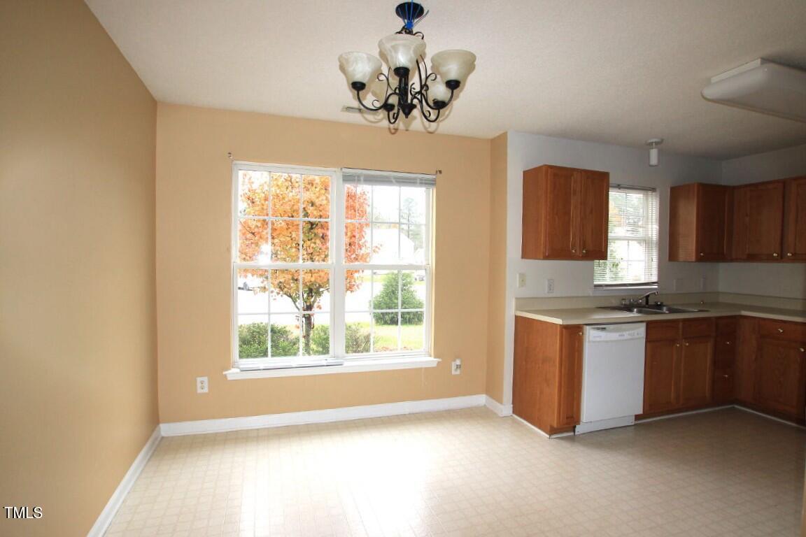 5201 Water Walk Lane Raleigh, NC 27616 - Photo 4 of 10 a kitchen with granite countertop a stove and a window