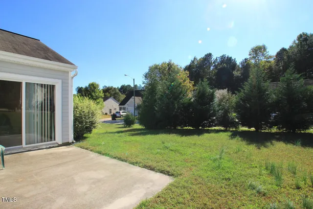 a backyard of a house with a garden and plants