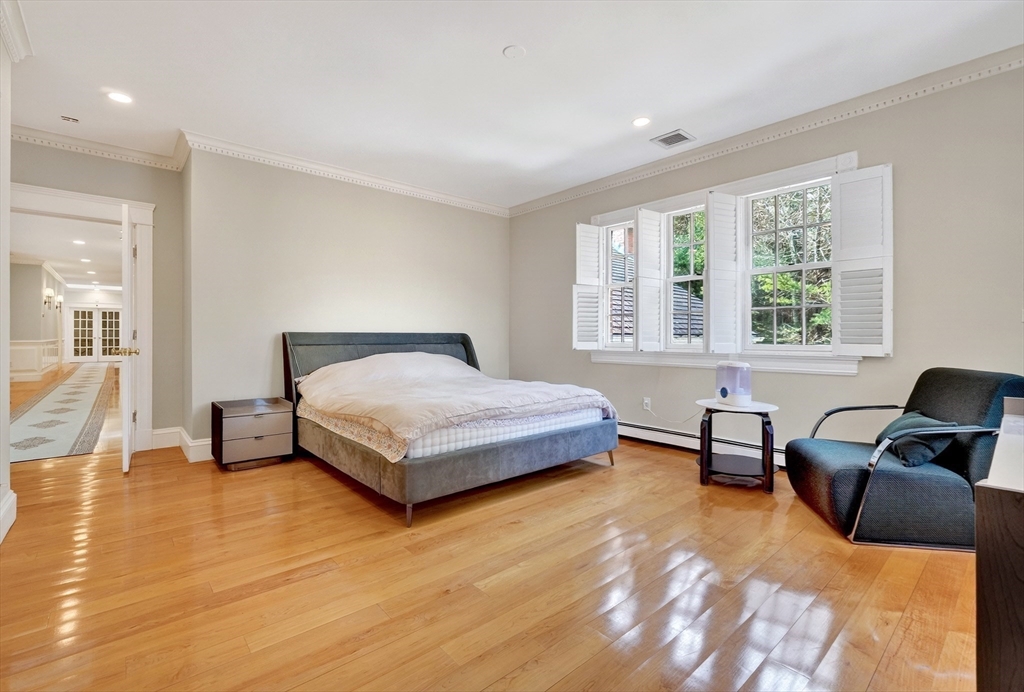 451 Wellesley Street Weston, MA 02493 - Photo 22 of 28 a bedroom with a bed and wooden floor