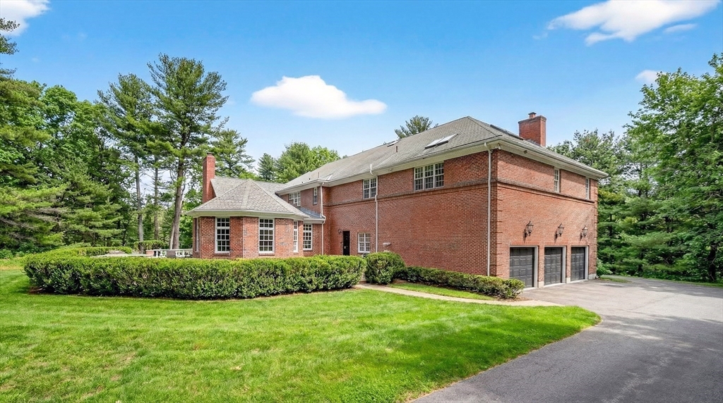 451 Wellesley Street Weston, MA 02493 - Photo 27 of 28 a front view of a house with a garden