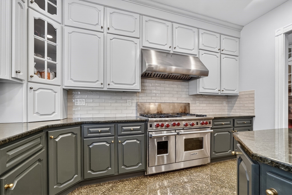 451 Wellesley Street Weston, MA 02493 - Photo 7 of 28 a kitchen with granite countertop a stove a sink and cabinets