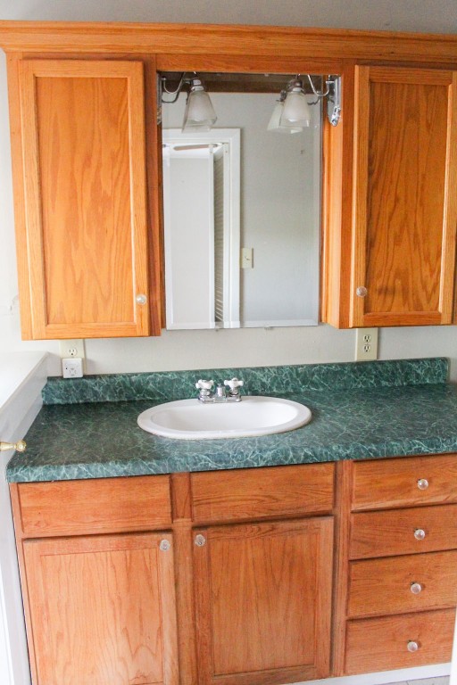 421 Farm To Market 845 Cameron, TX 76520 - Photo 18 of 37 a bathroom with a granite countertop sink and a mirror