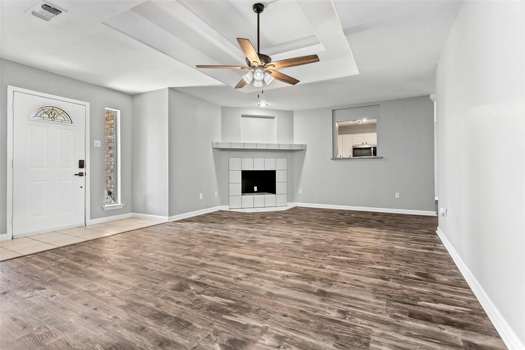 712 Billups Street Van Alstyne, TX 75495 - Photo 7 of 38 a view of an empty room with window and wooden floor