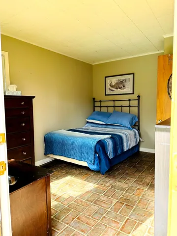 a living room with hard wood floors and a window