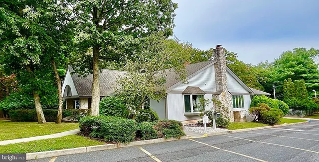 a living room with furniture a view of dining room and a chandelier
