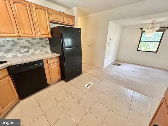 a kitchen with stainless steel appliances a refrigerator and cabinets