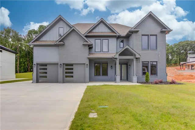 a front view of a house with a yard and garage